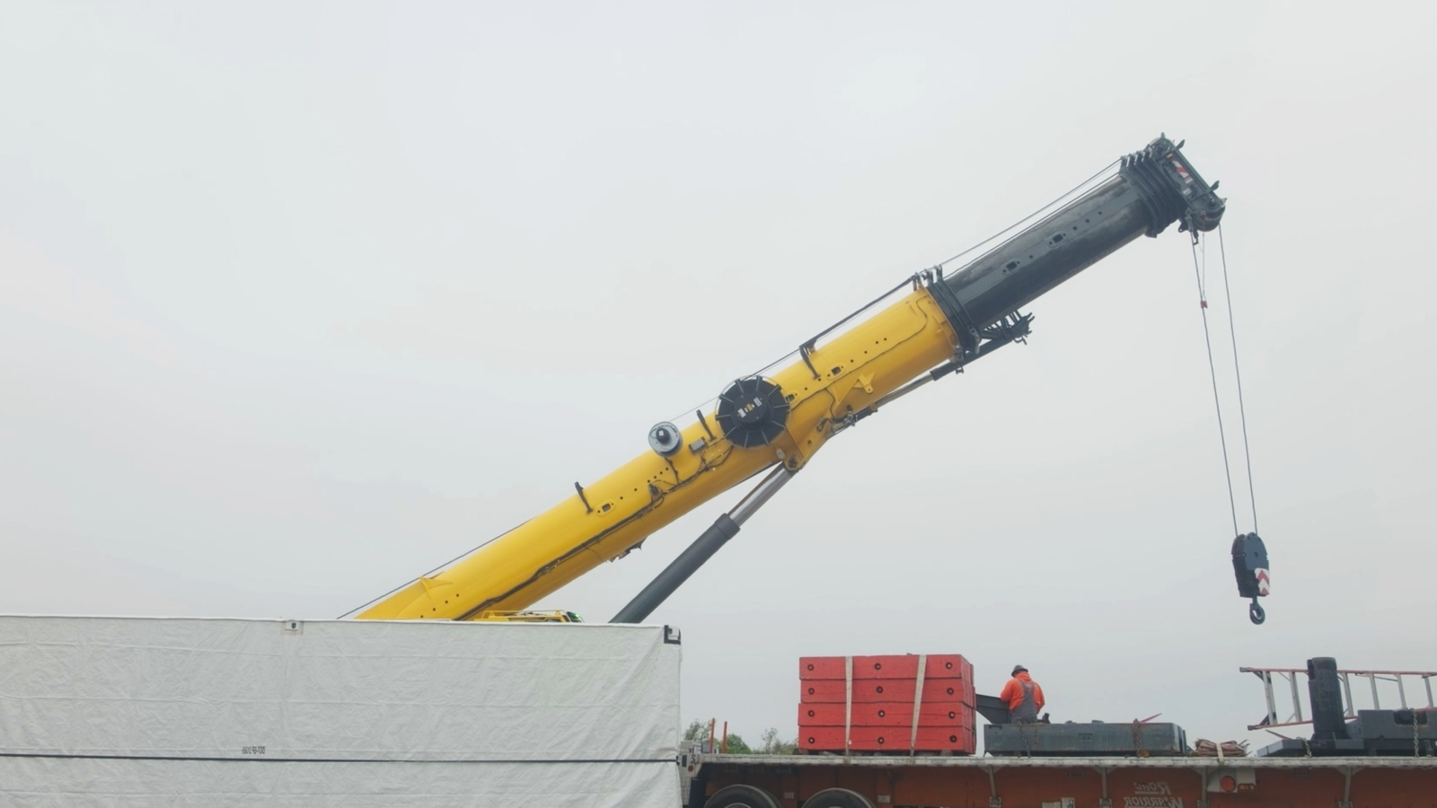Crane setting a modular battery enclosure on a California site