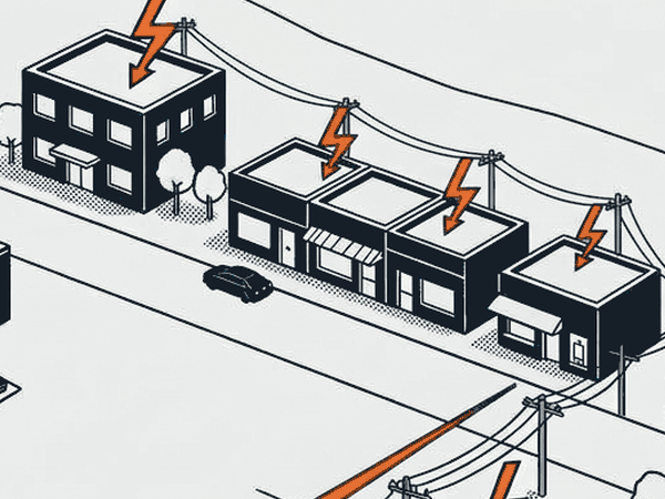 An office and a row of shops receiving power from the overhead line.